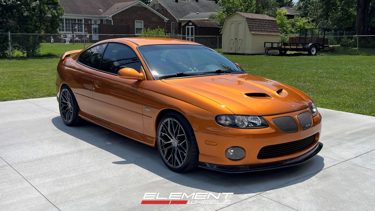 Staggered 19 inch Avant Garde M520R in Dark Graphite Metallic on a 2006 Pontiac GTO