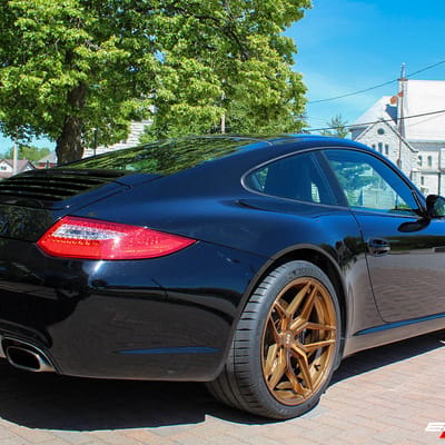 Staggered 19 Inch Variant Xenon in Brushed Bronze on a 2009 Porsche 911 C2