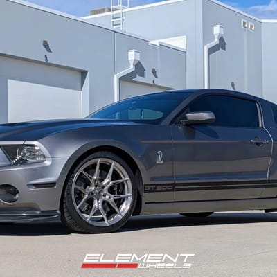 Staggered 20 inch Variant Nysa in Raw Titanium on a 2014 Ford Mustang GT500