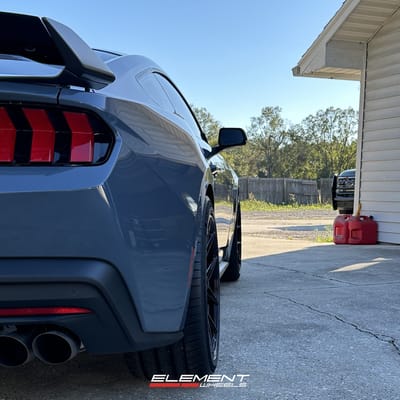 Staggered 20 inch Variant Nysa in Gloss Black on a 2024 Ford Mustang GT