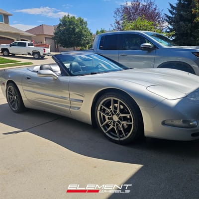 Staggered 19 inch Variant Helium in Gloss Gunmetal on a 1999 Chevrolet Corvette C5