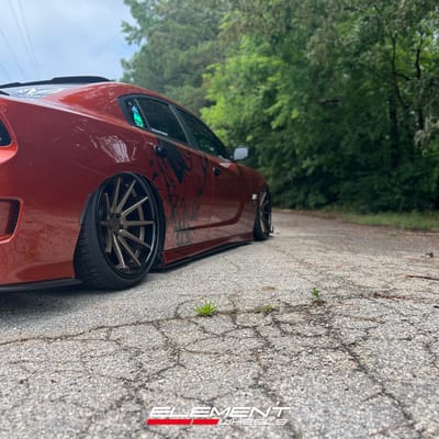 Staggered 22 inch Ferrada FR4 in Matte Bronze w/ Gloss Black Lip on a 2021 Dodge Charger