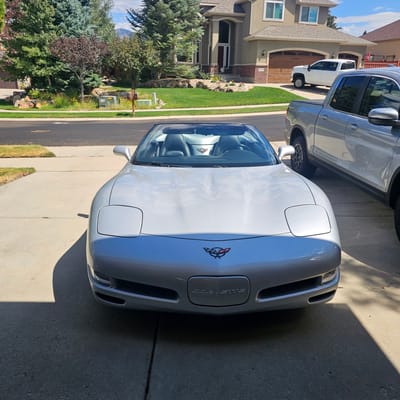 Staggered 19 inch Variant Helium in Gloss Gunmetal on a 1999 Chevrolet Corvette C5