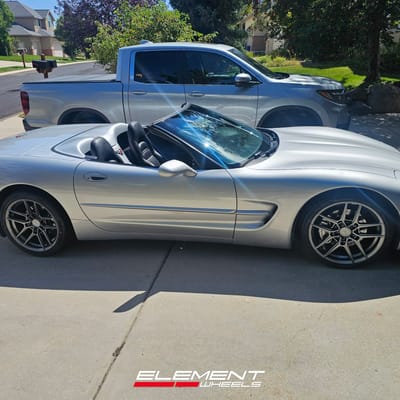 Staggered 19 inch Variant Helium in Gloss Gunmetal on a 1999 Chevrolet Corvette C5
