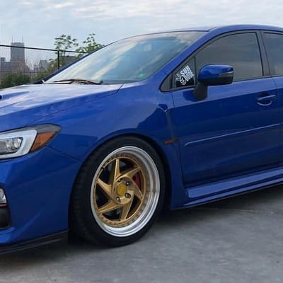 Regen5 R34 Brushed Gold w/ Polished Lip on a Subaru WRX