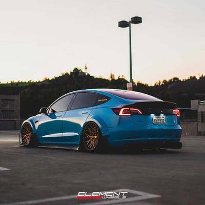20 inch Staggered Variant TWT-3P Polished Translucent Gold w/ Gloss Black Lip on a 2017 Tesla Model 3 w/ Custom Widebody