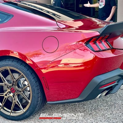 Staggered 20 inch Variant Nysa in Gloss Bronze on a 2024 Ford Mustang GT