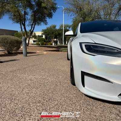 Staggered 21 inch Variant Formula Satin Black Center, Gloss Black Outer, Blue Fasteners on a 2021 Tesla Model S